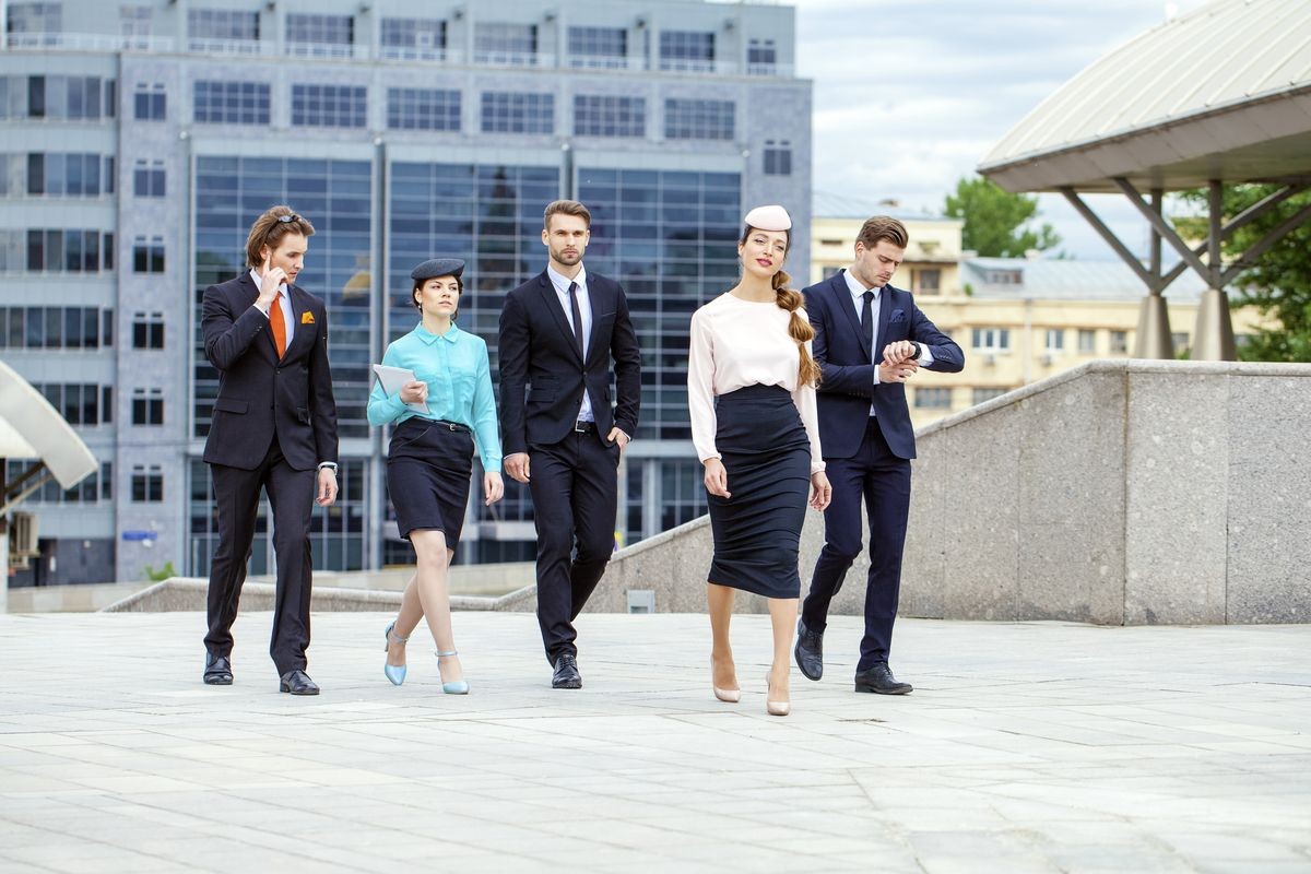 Business people are walking down the street on a background of business centers
